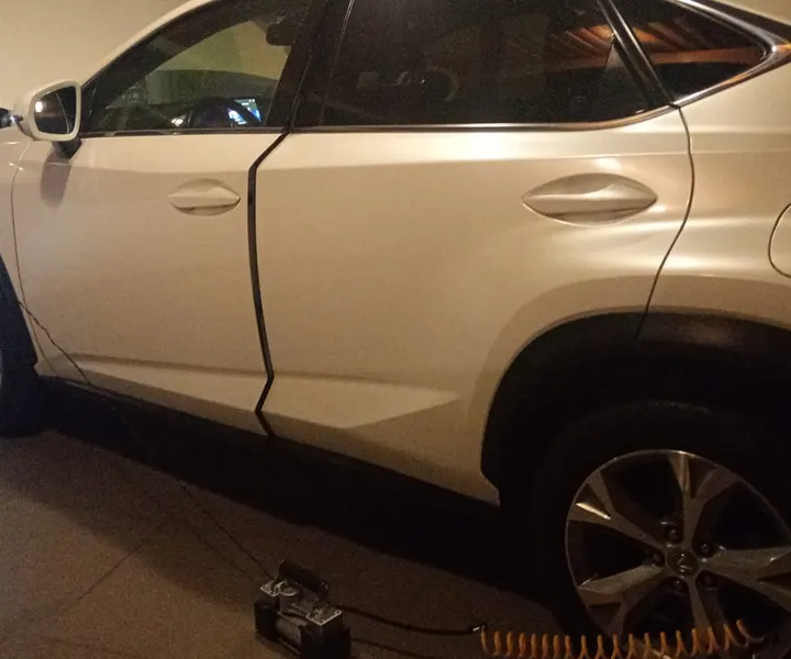 Manguera de aire conectada a una rueda de una SUV blanca.